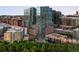 Aerial view of modern high-rise condos with glass windows amid city and lush greenery at 1700 Bassett St # 703, Denver, CO 80202