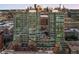 Aerial view of modern condo buildings featuring glass windows, pool, and city skyline at 1700 Bassett St # 703, Denver, CO 80202