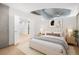 Comfortable bedroom boasts neutral decor, ceiling fan, and access to other rooms at 1700 Bassett St # 703, Denver, CO 80202