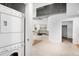 Laundry area with white, stacked washer and dryer, open to the living area at 1700 Bassett St # 703, Denver, CO 80202