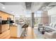 Open concept living area with hardwood floors, island with bar seating, and floor to ceiling windows at 1700 Bassett St # 703, Denver, CO 80202