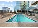 Rooftop pool with lounge chairs surrounded by cityscape views at 1700 Bassett St # 703, Denver, CO 80202