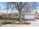 Charming brick home with a spacious front yard, large tree, and an attached two-car garage at 1748 Atwood St, Longmont, CO 80501