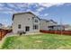 Backyard with lawn, privacy fence, patio with outdoor seating and an access to the house at 1246 Blackhaw St, Elizabeth, CO 80107
