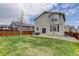 Backyard with patio, lawn, trees, and privacy fence with access to the house at 1246 Blackhaw St, Elizabeth, CO 80107