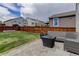 Backyard oasis with patio, modern outdoor furniture, lush lawn, and secure wood fence at 1246 Blackhaw St, Elizabeth, CO 80107