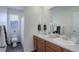 A well-lit bathroom featuring a dual sink vanity and a separate toilet room at 1246 Blackhaw St, Elizabeth, CO 80107