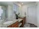 The bathroom features a dual sink vanity with granite countertops and modern fixtures at 1246 Blackhaw St, Elizabeth, CO 80107