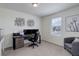Cozy bedroom featuring a functional desk, a gray accent chair, and ample natural light from the window at 1246 Blackhaw St, Elizabeth, CO 80107