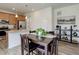 Open dining area featuring dark wood table and chairs next to the kitchen and its granite countertops at 1246 Blackhaw St, Elizabeth, CO 80107