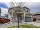 Two-story home featuring a covered porch and a two-car garage, partially obscured by a bare tree in the front yard at 1246 Blackhaw St, Elizabeth, CO 80107