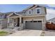 Inviting two-story home with a cozy front porch and a two-car garage, presenting a warm and welcoming facade at 1246 Blackhaw St, Elizabeth, CO 80107