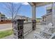Welcoming front porch with stone pillars, white railing, and chairs, offering a view of the neighborhood at 1246 Blackhaw St, Elizabeth, CO 80107