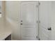 Hallway with a white door and a bench. The hallway provides access to additional rooms in the house at 1246 Blackhaw St, Elizabeth, CO 80107