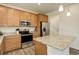 Bright eat-in kitchen featuring stainless steel appliances and a center island with granite countertops at 1246 Blackhaw St, Elizabeth, CO 80107