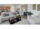 Open-concept living room with a view into the kitchen, showcasing modern furniture and stylish decor at 1246 Blackhaw St, Elizabeth, CO 80107