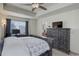An open primary bedroom features a rustic gray dresser with a television for entertainment at 1246 Blackhaw St, Elizabeth, CO 80107