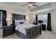 A well-lit primary bedroom features a ceiling fan, desk and a rustic gray bed frame at 1246 Blackhaw St, Elizabeth, CO 80107