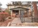 Brick two-story home with a stone path, wrought-iron fence, and landscaping at 471 N Humboldt St, Denver, CO 80218