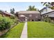 Spacious backyard featuring a lush lawn, garden beds, and a patio with outdoor seating at 4419 W 34Th Ave, Denver, CO 80212