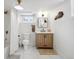 Well-lit basement bathroom featuring modern vanity, classic toilet, and a shower with curtain at 4419 W 34Th Ave, Denver, CO 80212