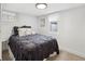 Charming basement bedroom with a cozy bed, soft lighting, and a pleasant atmosphere at 4419 W 34Th Ave, Denver, CO 80212