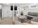 Inviting basement living room with plush gray sofa, modern shelving, and access to additional rooms at 4419 W 34Th Ave, Denver, CO 80212