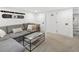 Comfortable basement living room featuring a plush gray sectional and stylish glass-topped coffee table at 4419 W 34Th Ave, Denver, CO 80212