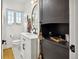 Bathroom with a white vanity, black fixtures, hexagon floor tiles, and natural light at 4419 W 34Th Ave, Denver, CO 80212