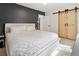 Bedroom with stylish sliding barn door, accent wall, and neutral tones at 4419 W 34Th Ave, Denver, CO 80212