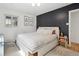 Stylish bedroom features a black accent wall, a comfortable queen bed, and ample natural light at 4419 W 34Th Ave, Denver, CO 80212