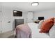 Cozy bedroom with a TV, dresser, and white walls with white trim at 4419 W 34Th Ave, Denver, CO 80212