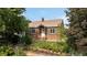 Charming brick home with landscaped front yard and black iron fence at 4419 W 34Th Ave, Denver, CO 80212