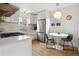 Modern white kitchen features stainless steel appliances, a gas range, and an adjacent breakfast nook at 4419 W 34Th Ave, Denver, CO 80212