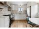 Well-lit kitchen with white cabinets, stainless steel appliances, and tiled backsplash at 4419 W 34Th Ave, Denver, CO 80212