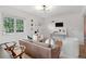 Bright living room with hardwood floors, modern light fixture, leather couch, and neutral decor at 4419 W 34Th Ave, Denver, CO 80212