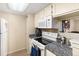 Kitchen with granite countertops and white cabinets at 4400 S Quebec St # 204N, Denver, CO 80237