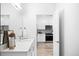 Bright bathroom with a modern vanity, stylish finishes, and view into the kitchen at 2851 W 52Nd Ave # 304, Denver, CO 80221