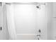 Bright bathroom with white tiled walls and a shower featuring sleek chrome fixtures at 2851 W 52Nd Ave # 304, Denver, CO 80221