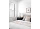 Cozy bedroom with a neutral color palette, side table decor, and natural light from the window at 2851 W 52Nd Ave # 304, Denver, CO 80221