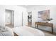 Modern bedroom with a view into the kitchen, featuring neutral colors and natural light at 2851 W 52Nd Ave # 304, Denver, CO 80221