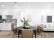 Bright dining area adjacent to modern kitchen features stylish decor, and cohesive design at 2851 W 52Nd Ave # 304, Denver, CO 80221