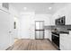 Modern kitchen with stainless steel appliances, white cabinetry, and a sleek design at 2851 W 52Nd Ave # 304, Denver, CO 80221