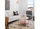 Bright living room featuring a modern sofa, stylish rug, and contemporary decor with natural light at 2851 W 52Nd Ave # 304, Denver, CO 80221