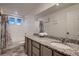 Bright bathroom featuring a shower-tub combination, granite countertops, and a modern vanity at 4526 N Quatar Ct, Aurora, CO 80019