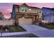 Inviting home boasting stone detailing, green lawn, and a convenient two-car garage at 4526 N Quatar Ct, Aurora, CO 80019