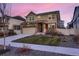 Attractive home featuring stone accents, well-kept lawn, and a driveway leading to a two-car garage at 4526 N Quatar Ct, Aurora, CO 80019