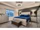 Elegant main bedroom with tray ceiling, plush bed, and mirrored dressers at 4526 N Quatar Ct, Aurora, CO 80019