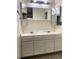 Double vanity bathroom with mirrored medicine cabinets at 9573 E Kansas Cir # 57, Denver, CO 80247