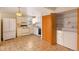 Kitchen boasts white appliances, ample cabinetry, and adjacent laundry area at 9573 E Kansas Cir # 57, Denver, CO 80247